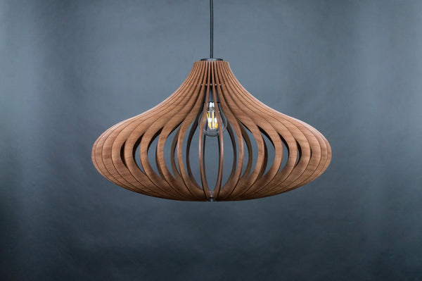 May include: A wooden pendant light with a unique, organic shape. The light is made of thin, curved strips of wood that create a lattice-like pattern. The light is suspended from a black cord and has a single light bulb.